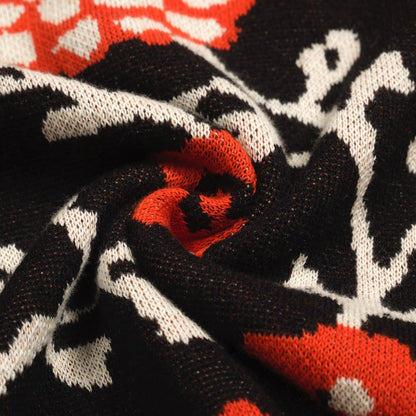 Polo tricoté rétro à col en V floral noir pour hommes